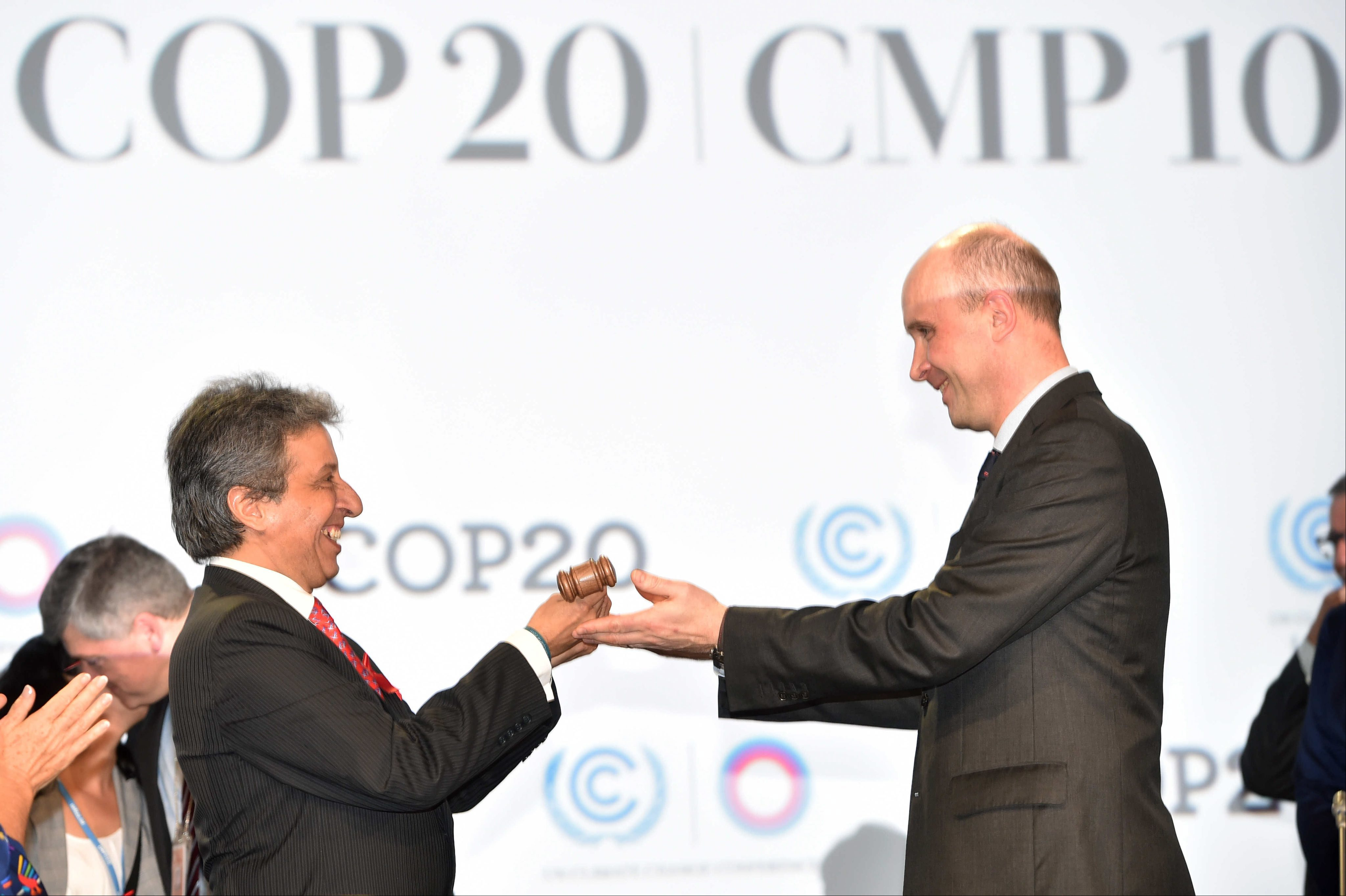 epa04510919 Outgoing COP19 president, Polish Marcin Korolec (R) symbolically hands over his position to Peruvian Environment Minister Manuel Pulgar Vidal (L) during the opening of the the 20th United Nations Climate Cha